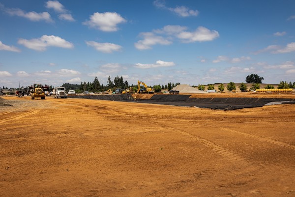 Breaking Ground red clay with construction beginning and blue skies tiny clouds